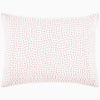 A John Robshaw Organic Hand Stitched Lotus Quilt with a pink and white pillow with dots on an organic cotton voile coverlet.