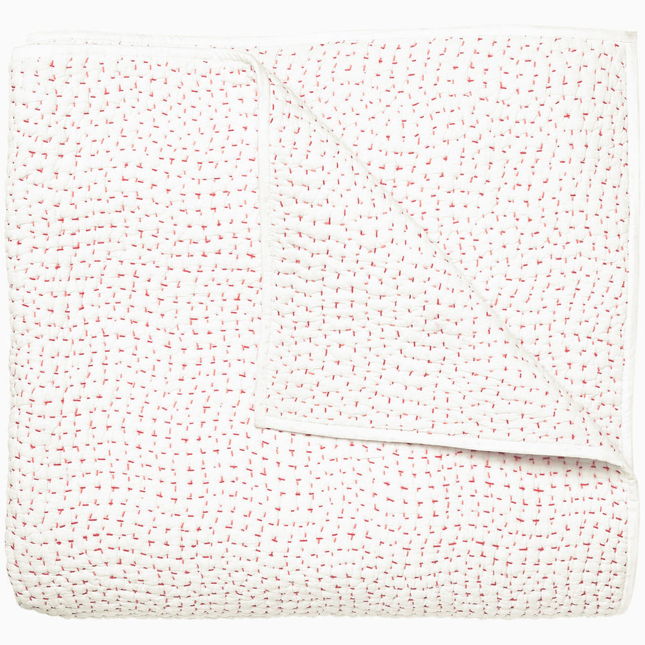 A white and pink Organic Hand Stitched Lotus Quilt with dots, by John Robshaw.
