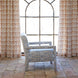 The John Robshaw Square Chair in Marmar Marigold and Natesh Sand, featuring custom upholstery and performance fabric, is shown facing left on a tiled floor in front of a large arched window with patterned curtains.