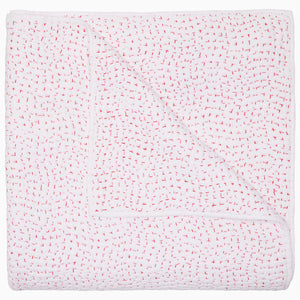 The John Robshaw Organic Hand Stitched Lotus Quilt, shown against a plain white background, is crafted from elegant organic cotton and features meticulous hand stitching with small, evenly spaced red details and a neatly finished edge.