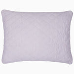 A John Robshaw Nandi Lavender Quilt featuring block printing on a white cotton background.