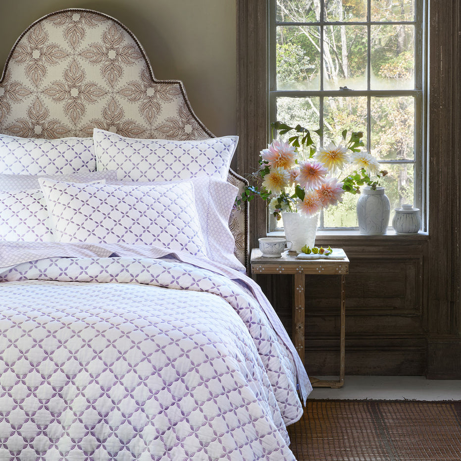 A Layla Lavender Quilt by John Robshaw, made of cotton voile, with a purple and white pattern inspired by Mughal gardens.