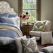 A bedroom with a bed, John Robshaw hand block printed Verdin Dark Sage Decorative Pillows, and a window.