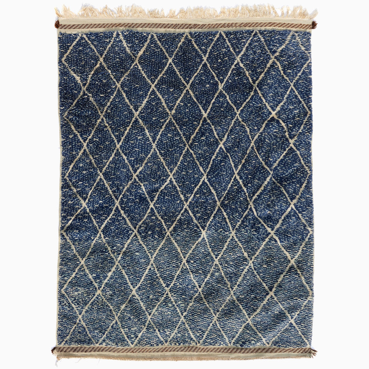 Blue Village 2 Wool Rug: a blue rectangular handwoven Moroccan rug with a white lattice design and fringed ends.