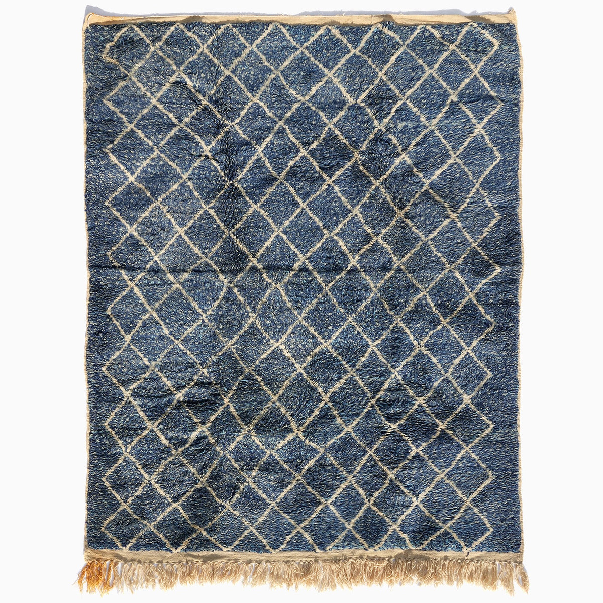 Blue Village Wool Rug with a white diamond pattern, rectangular shape, and fringed ends.