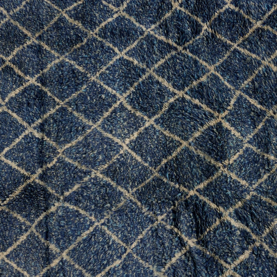 Dark blue handwoven Blue Village Wool Rug by John Robshaw with a white diamond grid pattern.