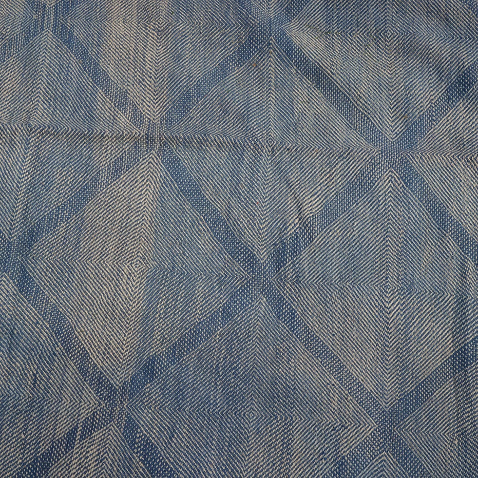 Big Zanafi Wool Rug featuring a handwoven blue and white repeating diamond pattern.