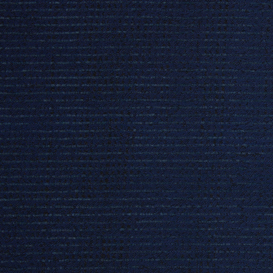 Close-up of dark blue woven fabric, specifically the Bijal Indigo Performance Fabric featured on the Round Swivel Chair by John Robshaw, showing a detailed textured pattern with visible horizontal and vertical threads intersecting throughout the surface.