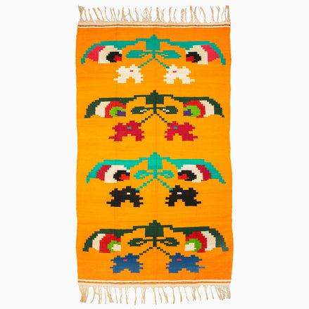 A vibrant Flowers in a Vase Rug from Punjab, crafted with meticulous weaving and adorned with fringes, all set against a crisp white background by John Robshaw.