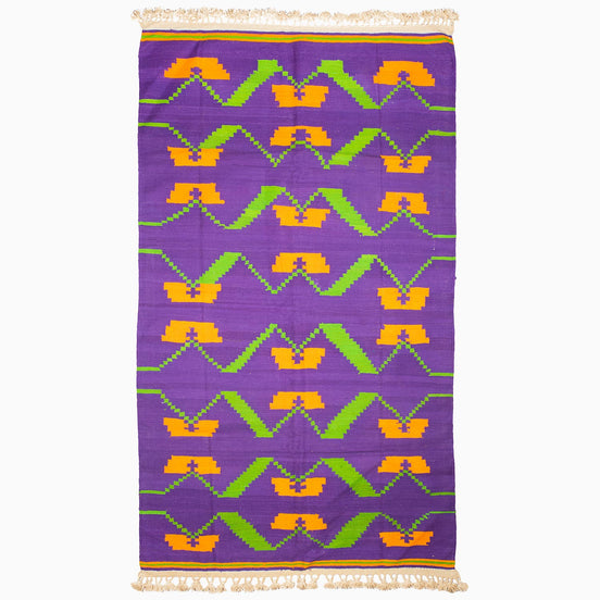 A Purple Orange Murmur Rug from John Robshaw, with a unique design, showcasing vibrant purple and orange hues.