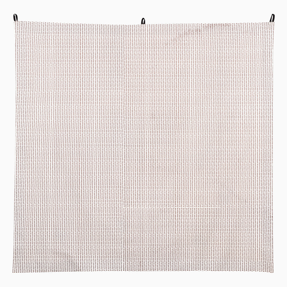 Square Promenade Tapestry featuring a small, repetitive brown leaf pattern on a white background, suspended by three black loops at the top edge.
