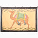 John Robshaw Cantering Camel Tapestry featuring hand-painted Rajasthan art of a camel in motion, wearing an ornate saddle and beaded anklets, framed by a dark, floral patterned border.