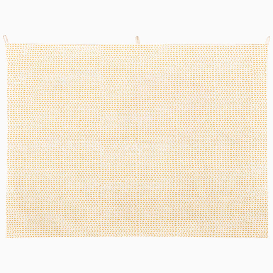 John Robshaw White Elephant Walking Tapestry, a rectangular wall hanging featuring a repeating gold leaf elephant pattern on a cream background.