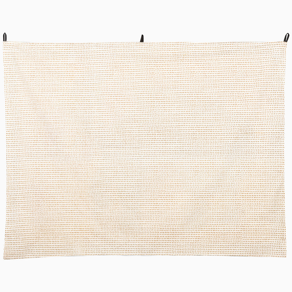 John Robshaw Elephant Tromping Tapestry, a rectangular wall hanging featuring a repeating pattern of small tan dashes in horizontal rows against a cream background in the style of Rajasthan art.