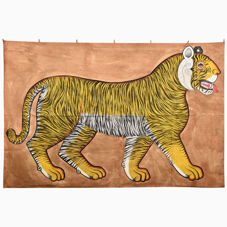 A rectangular Prowling Tiger Tapestry by John Robshaw featuring an Iqbal Tiger in profile with a striped body, bared teeth, and a protruding tongue, set against a solid tan background.