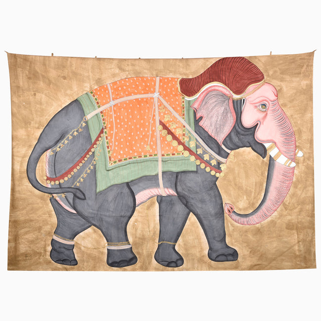 On the Move Tapestry featuring hand-painted elephant wall art with pink accents and an orange and green saddle on a gold background.