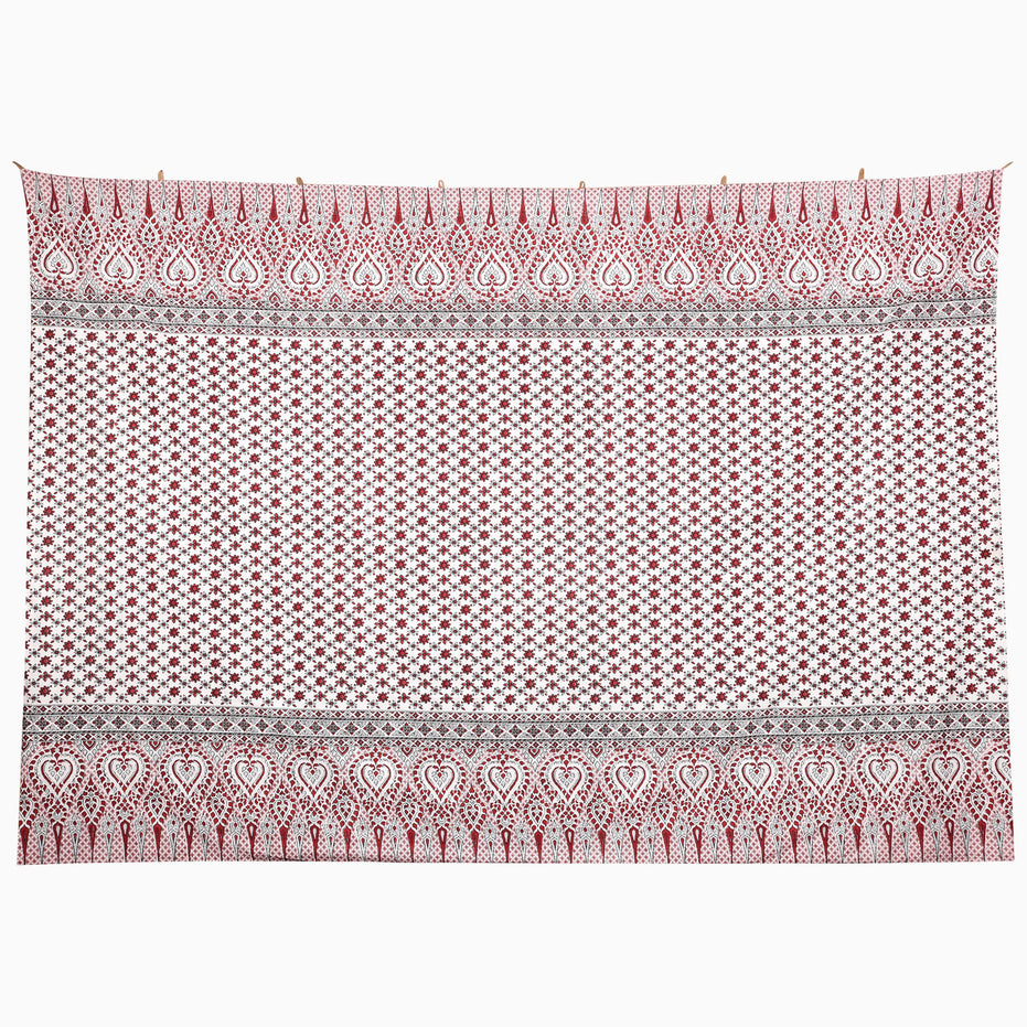 The On the Move Tapestry is a rectangular embroidered jhool with a white field of red floral patterns, bordered by red teardrop motifs and geometric lines.