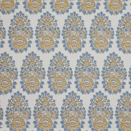 A blue and yellow floral pattern, featuring block prints, made with Lanka Marigold Performance Fabric by John Robshaw.