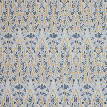 A blue and yellow floral pattern inspired by the Mughal gardens of Shalimar Bagh, featuring the Marmar Marigold Performance Fabric by John Robshaw.