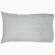 A Cala Sage Organic Sheets pillow with a geometric pattern by John Robshaw.