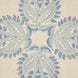 A Verdin Lapis decorative pillow with a hand block printed blue and white floral design on a beige fabric by John Robshaw.