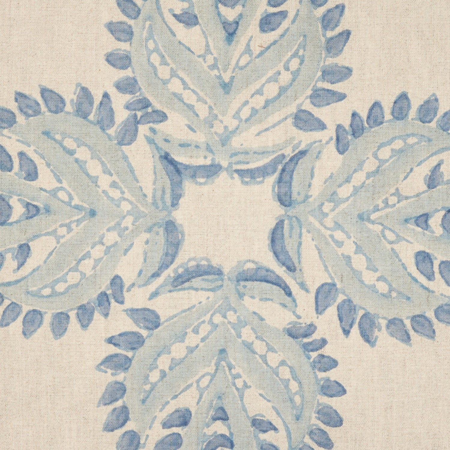 A Verdin Lapis decorative pillow with a hand block printed blue and white floral design on a beige fabric by John Robshaw.