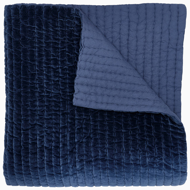 A John Robshaw Velvet Indigo Quilt on a white background.