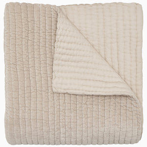 A soft, beige Velvet Sand Quilt by John Robshaw on a white background.