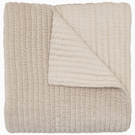A soft, beige Velvet Sand Quilt by John Robshaw.