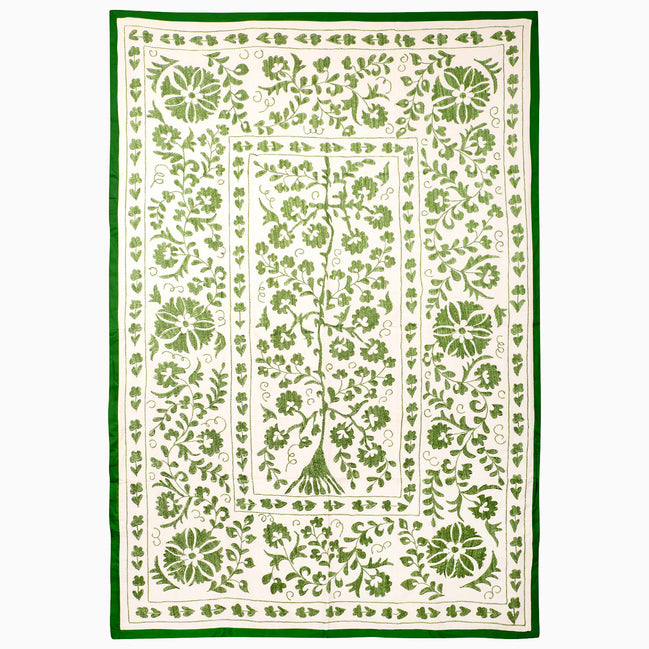 John Robshaw Drawn In Thread Suzani Blanket, a rectangular throw with an off-white background, intricate botanical embroidery, vines, and a solid green border.