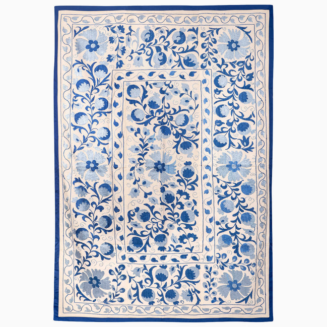 John Robshaw Indigo Sky Suzani Blanket featuring a rectangular off-white design with a repeating vintage blue floral border.