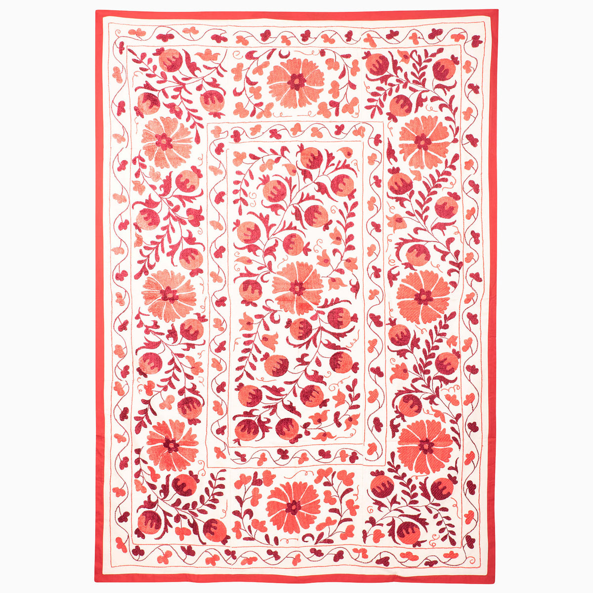 A rectangular John Robshaw Red Clay Suzani blanket made of white textile featuring red floral and pomegranate embroidery in a vintage pattern.