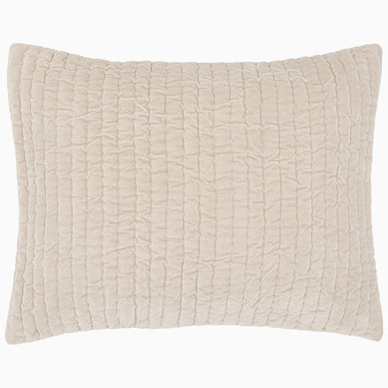 A soft beige Velvet Sand Quilt pillow, hand quilted by John Robshaw.