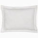 A decorative rectangular white pillow, part of the Amina Ecru Duvet Set by John Robshaw, featuring intricately woven lines and subtle floral patterns, crafted from the finest quality cotton linen.