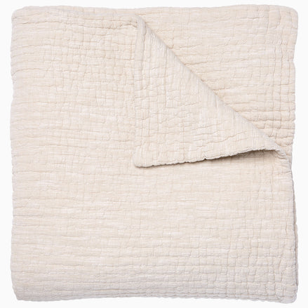 A Vivada Sand Woven Quilt, hand-stitched quilt, on a white background by John Robshaw.