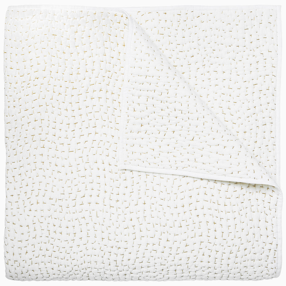 A white cotton voile coverlet featuring John Robshaw's Organic Hand Stitched Sand Quilt with subtle white dot patterns.