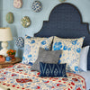 A John Robshaw Custom Dara Bed in a room with a blue wall, available for white glove delivery.
