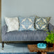 A Verdin Euro couch with blue pillows and a potted plant made of cotton linen blend fabric.