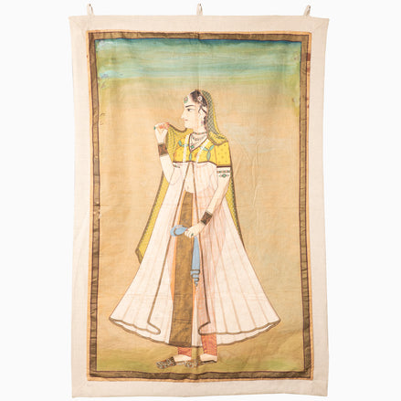 A Princess With Faded Blue Sky Tapestry, hand-painted by John Robshaw, of a woman holding a pipe, acquired while traveling in India.