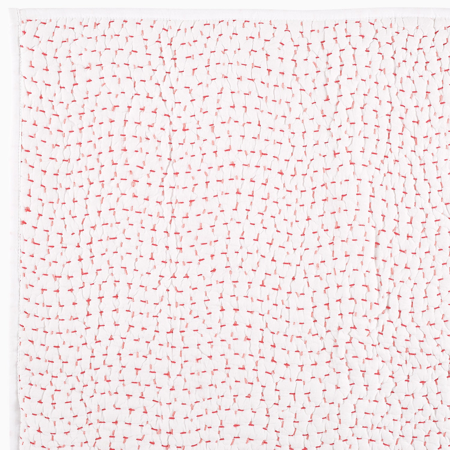 A white piece of Organic Hand Stitched Lotus Quilt paper with hand-stitched red and white lines on it.