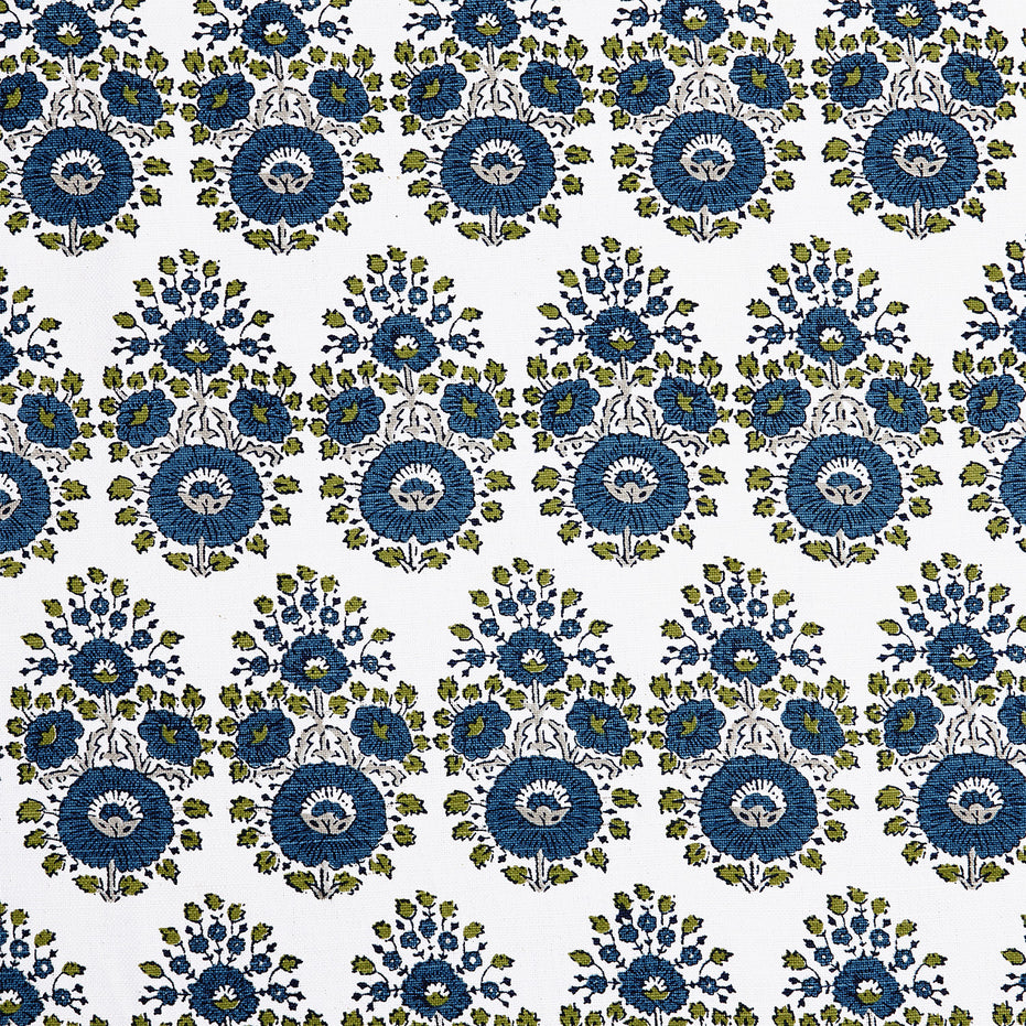 A blue and green floral pattern on a white background featuring traditional craftsmanship of the Lanka Peacock Fabric by John Robshaw.