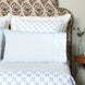 A bed with John Robshaw's Cinde Light Indigo Organic Sheet Set bedding and pillows.