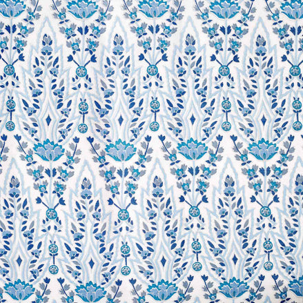 A hand block printed Marmar Turquoise Fabric with a blue and white floral pattern on a crisp white background, inspired by the stunning Mughal gardens in India, created by John Robshaw.