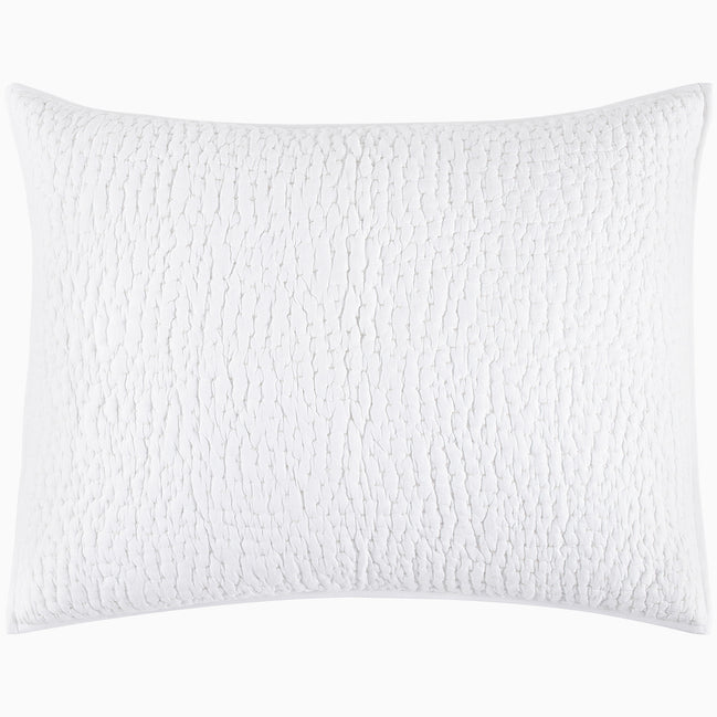 An Organic Hand Stitched White Quilt from John Robshaw with a cotton voile coverlet on a white background.
