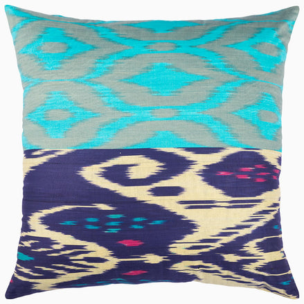 A John Robshaw Light Blue Diamond Ikat Pillow with a blue and green tie-dyed design.