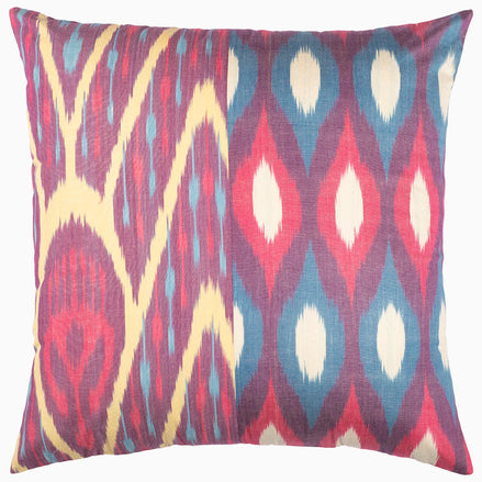 A John Robshaw Octagon Diamond Ikat Pillow 2 with a pink, blue and yellow design created by skilled artisans, showcasing natural colors.