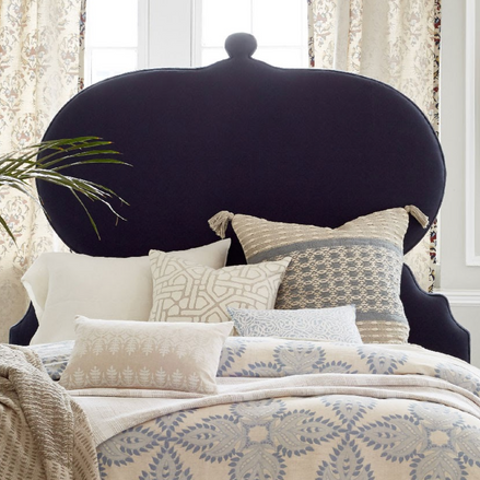 A bed with a Custom Orissa headboard and pillows by John Robshaw available for Free Shipping.