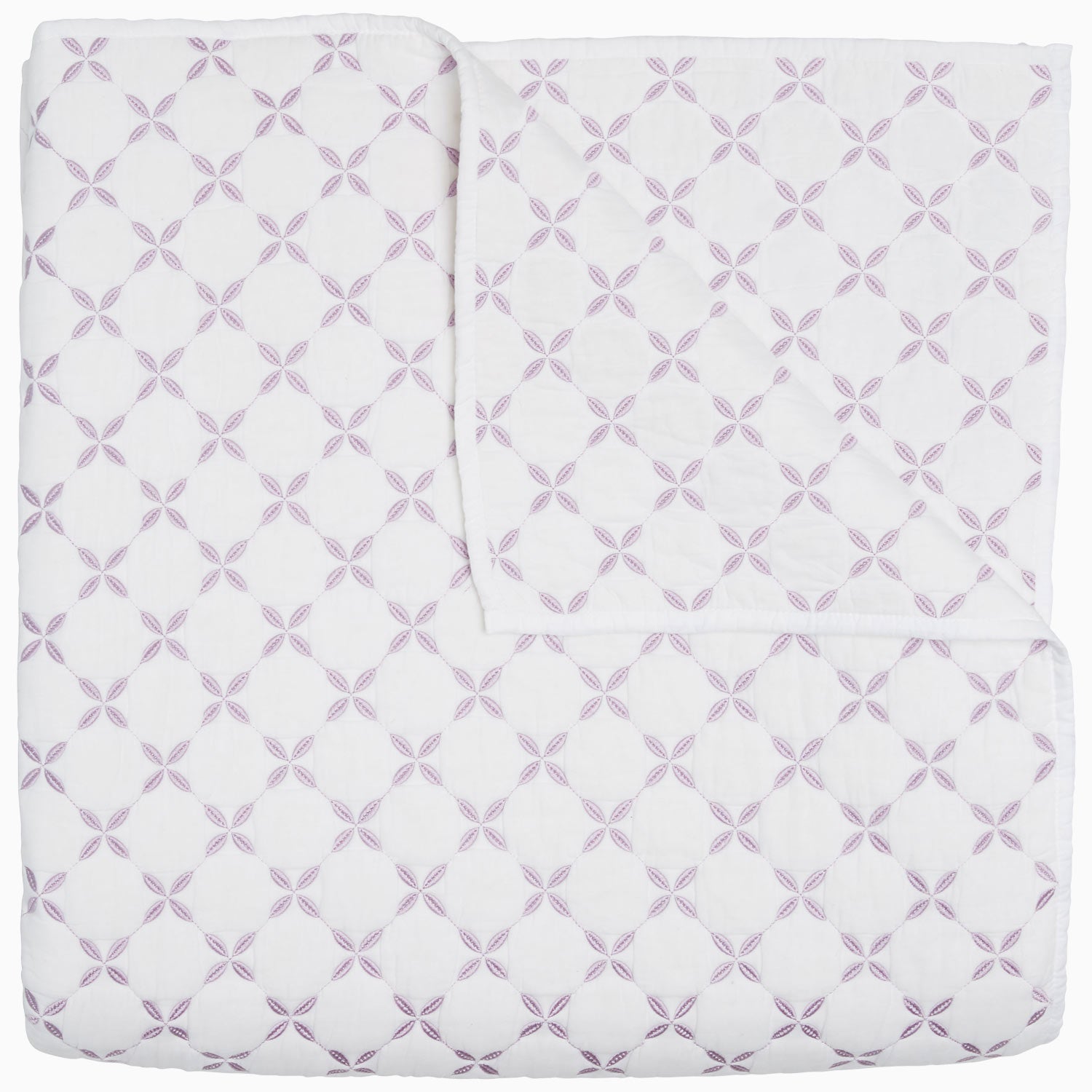 A Layla Lavender quilt by John Robshaw, made from cotton voile, with a cross pattern in white and purple, inspired by Mughal gardens.