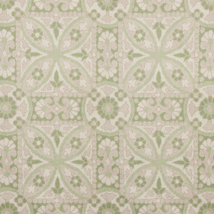 A printed green and white tile pattern with a floral design on John Robshaw's handmade Oman Sage Fabric.