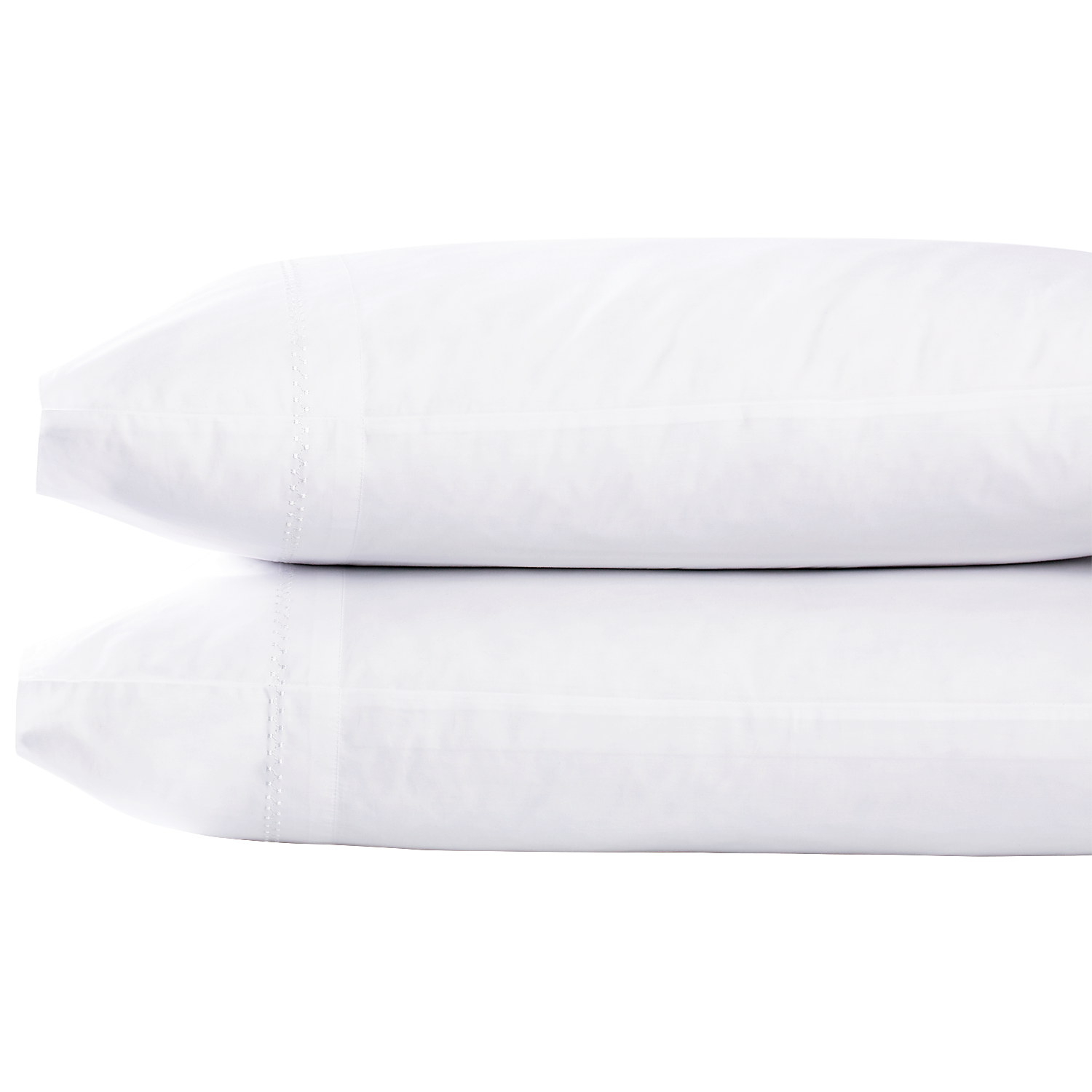 Two Anketi White Organic Sheet Set pillows from John Robshaw, stacked on top of each other.